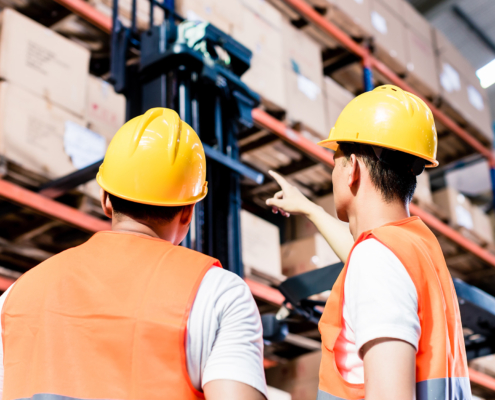 Worker team taking inventory in logistics warehouse