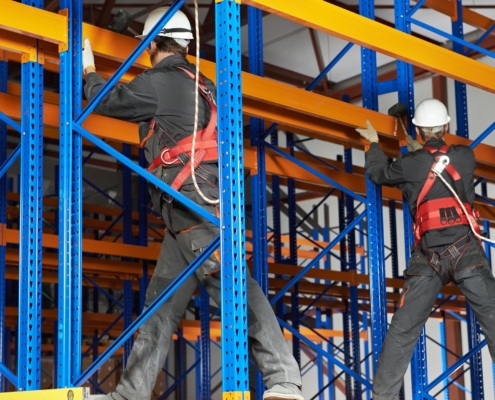 Workers installing pallet rack system