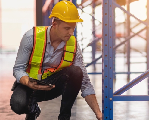 worker installing warehouse rack