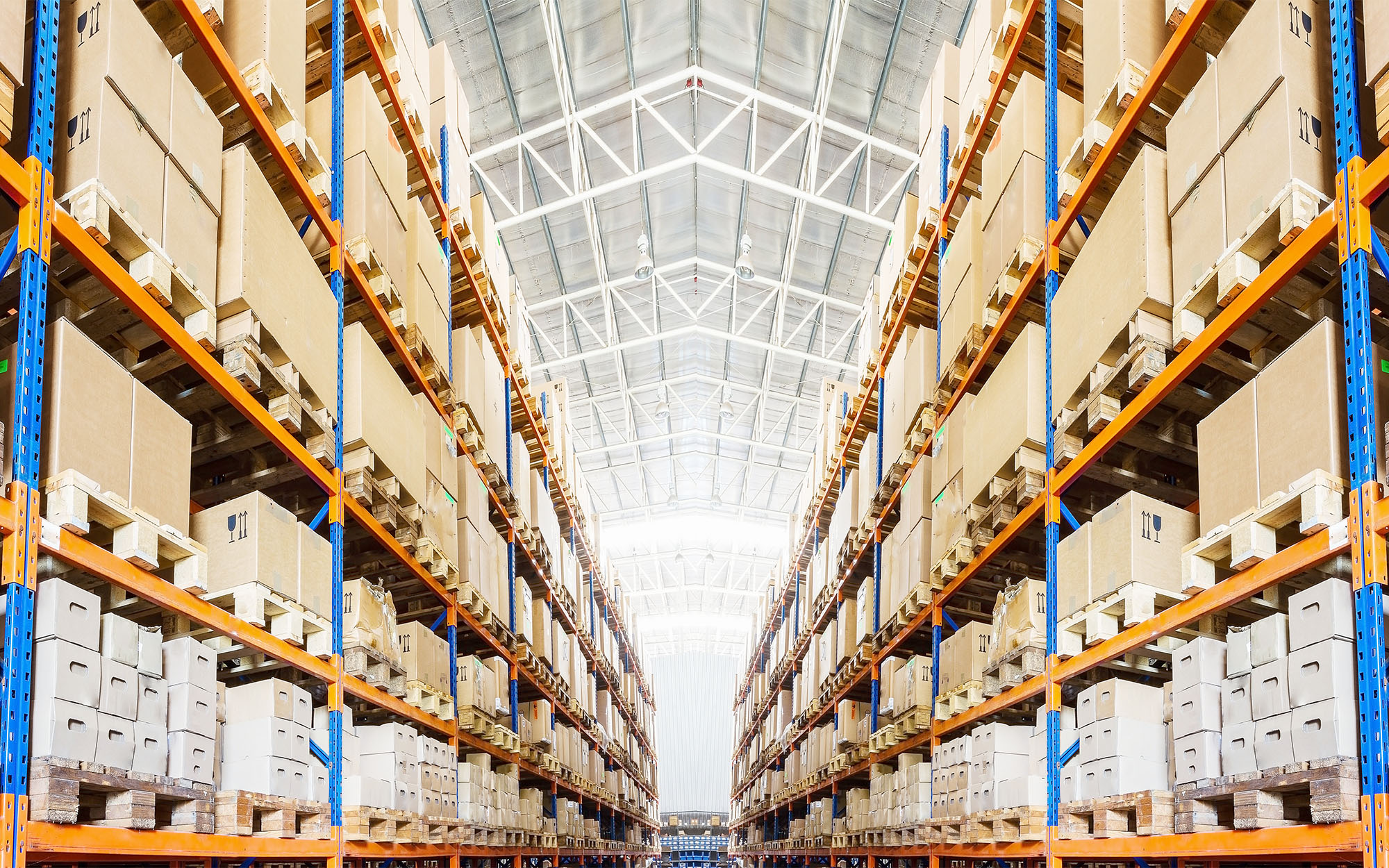 Rows of shelves with boxes in modern warehouse